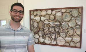 Lake Orion High School art teacher Sam Rimi, who is also a LOHS alumni, took third place in the all-media show with his piece, "Wagon Landscape." The piece was created from stumps from his parents' Christmas tree farm that he sanded down and adhered to the board. Photo by Cathy Kimmel-Srock.