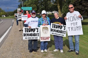 (Left to right) Orion residents Ross Ensign, Suzy Corker, JoAnn Van Tassel and Carl Cyrowski joined the flash mob rally last Tuesday supporting Donald Trump for president in the Nov. 8 general election. Local businessman Carl Cyrowski organized the flash mob through emails and word-of-mouth as a part of the grassroots effort. Photo by Jim Newell