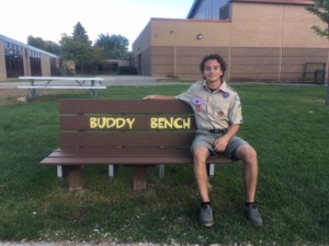 Avery DePauw sits on one of three Buddy Benches he constructed at Carpenter Elementary. Photo provided.