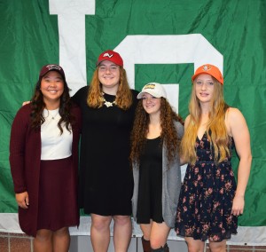 Lake Orion High School student-athletes (from left) Moyea Russel, Shelby Misiak, Jamie Bell and Sarah Hennings all signed national letters of intent on Nov. 9 to continue their playing careers in college. Photo by Jim Newell.
