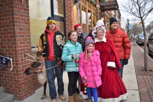 (From left) Belle the reindeer, Dawson Moll, and the Novak’s – Ava, 11, Sophie, 13, Ella, 8, Tera (background) and Steve – joined Mrs. Claus in downtown LO. Dawson and Jen Moll (not pictured) brought seven-year-old Belle from their farm, Carousel Acres Farm in South Lyon. 