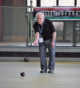 Ted Trochim tosses a Bocce Ball during the senior Olympic games.
