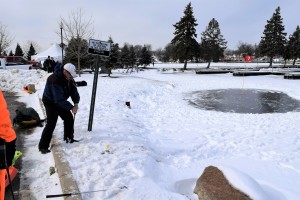 Tim Williams chips to the ‘green’ during a round  of ice golf on Lake Orion. They do this for fun?