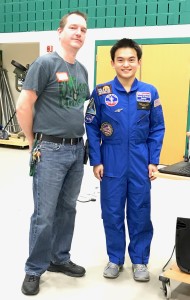 Oliver Yu, right, wearing his Space Camp uniform, talks at the Lake Orion High School Makers Fair about his camp experience, standing alongside Steve Tighe, high school science teacher. Photo by Susan Carroll.