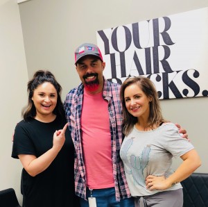 Garrett Hoffman got his beard dyed pink Wednesday at the Fringe Salon in Lake Orion. Owner Lauren Knapp (right) is Hoffman’s longtime friend and Jordan Rymer (left) actually colored his beard. Photo provided.