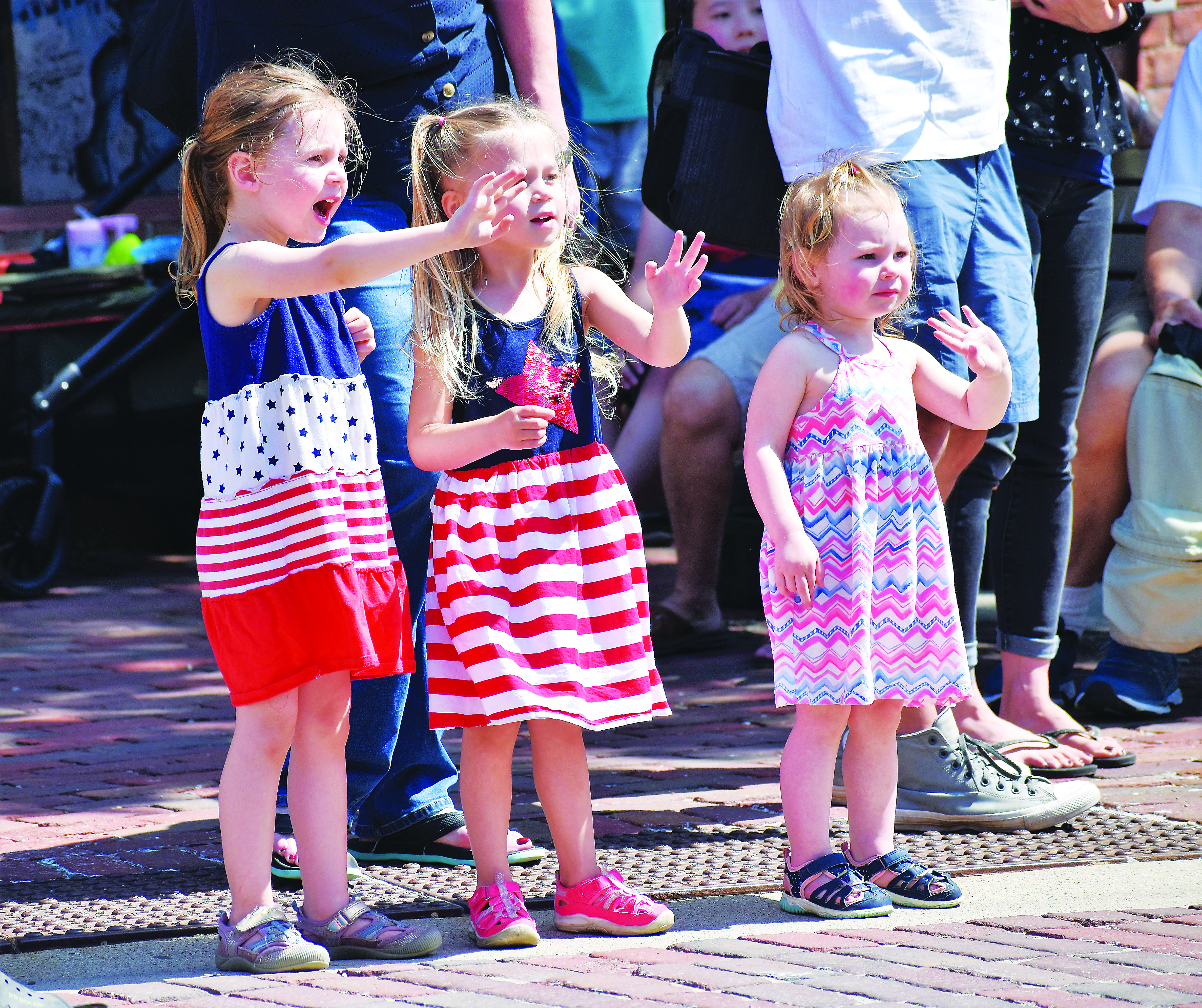 three girls waving