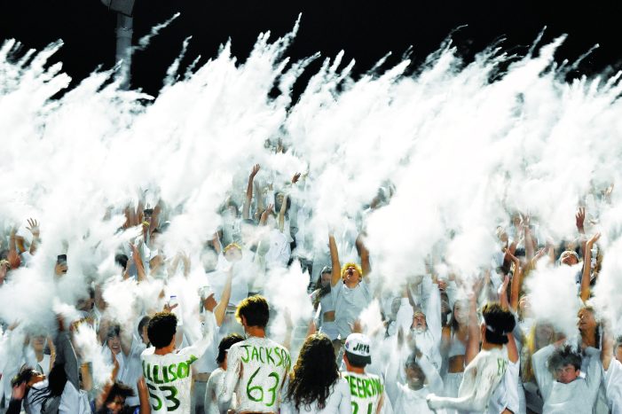 LOHS student section has White Out theme during varsity football 28-25 against Rochester Adams