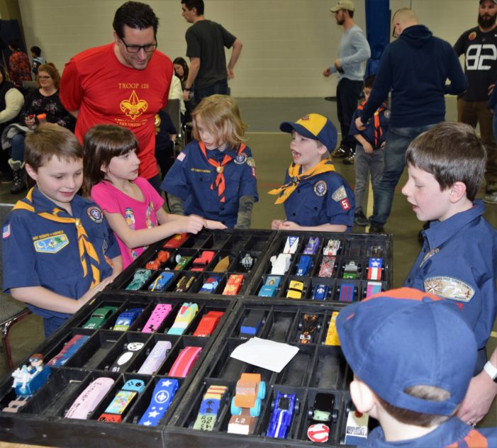 Vrrroom! Cub Scouts in Pack 512 zoom toward the finish line during annual Pinewood Derby race on Saturday