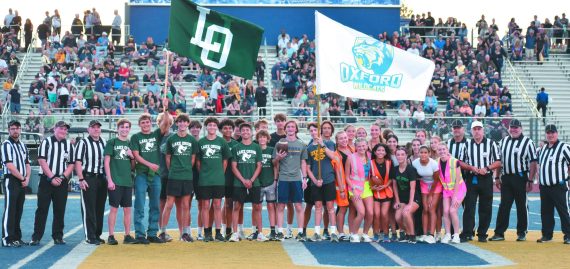 Cross country teams run the game ball from LOHS to Oxford High School